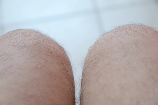 istock One mans hairy leg isolated on white background 590594332