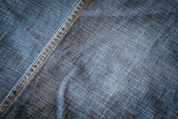 istock Texture of dark fabric blue jeans textile with seam. 590594508
