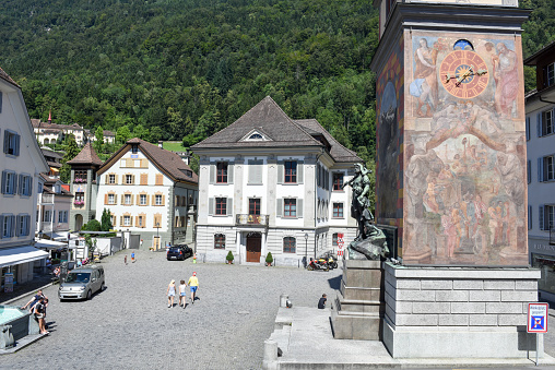 Altdorf, Switzerland - August 7, 2016: people walking and looking at Wilhelm Tell monument on the cantonal capital of Altdorf in the Canton of Uri, Switzerland