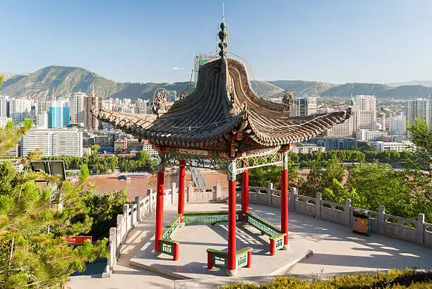 Pavilion in the Baitashan Park in Lanzhou, with skyline of the city in background