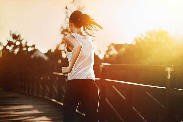 istock Beautiful jogger crossing bridge 590596056