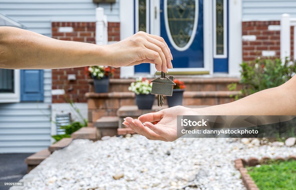 Handing Over the Key from a New Home Selling Stock Photo