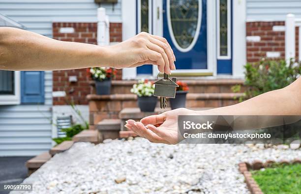Handing Over The Key From A New Home Stock Photo - Download Image Now - Selling, Home Interior, Residential Building