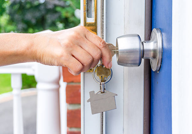 istock hand opening a door with keys 590597350