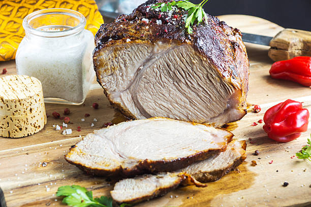 istock Roasted pork with herb on wooden background 590599522