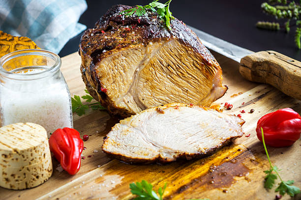 istock Roasted pork with herb on wooden background 590599626
