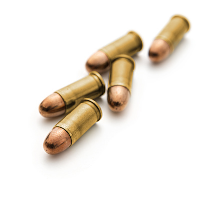 A group of 9mm bullets for a gun on white background