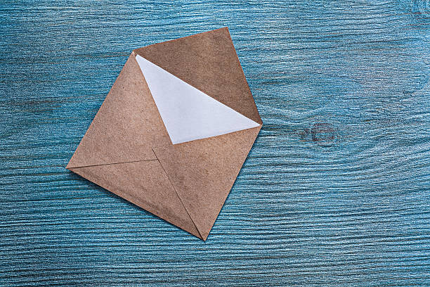 istock Vintage post envelope with message on wooden board 590600774