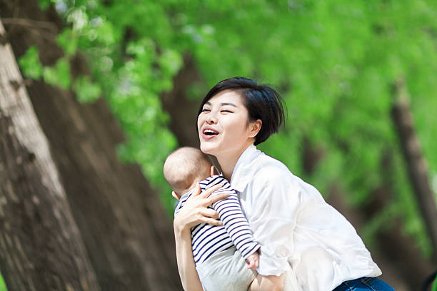 istock Happy young mother embracing baby on nature background 590600780