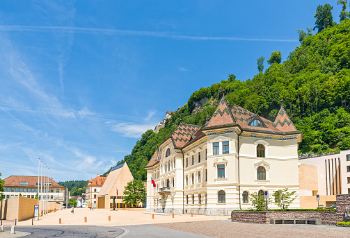 Vaduz, Liechtenstein - July 8, 2016: The Parliament building with Vaduz Castle in Liechtenstein. Principality of Liechtenstein is one of the world's smallest countries. It is located between Switzerland and Austria. its capital is Vaduz.