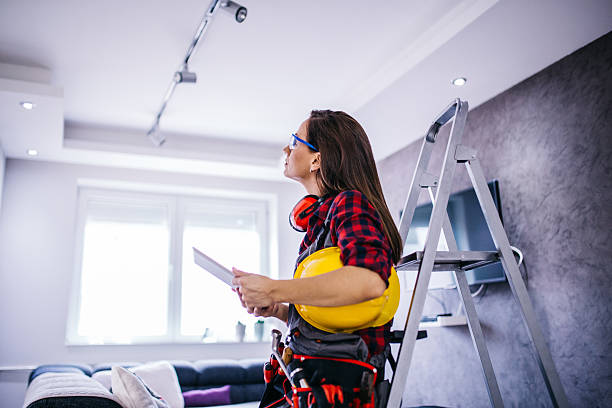 Search new ideas Female construction worker with tools.Female takes care of the house.Woman handyman.There helmet on his head and a tool belt on.Tablet and search woman wearing tool belt stock pictures, royalty-free photos & images