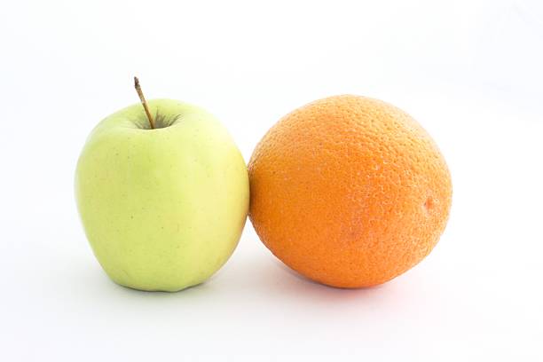 istock Yellow Apple and orange on a white background 590601044