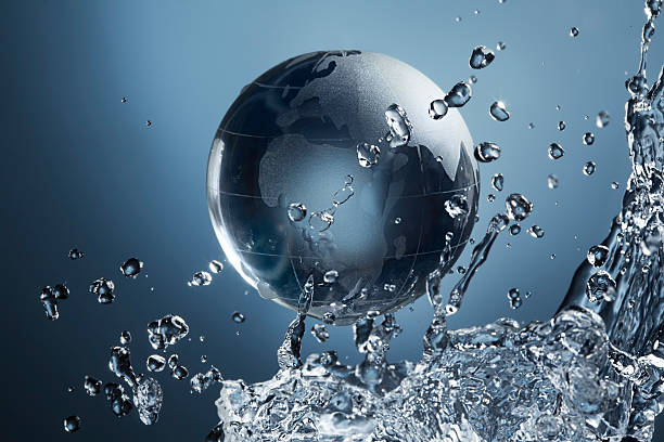 istock glass globe planet in drop water splash on blue background 590601518