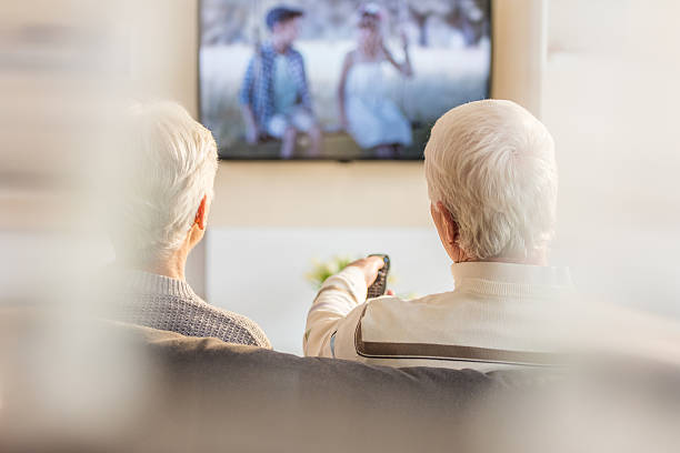 istock Senior couple watching television show 590602280