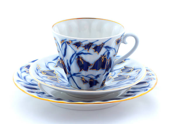 Porcelain cup, plate and saucer on a white background, isolated