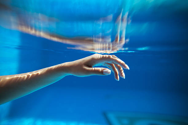 istock Woman hand in pool 590603816