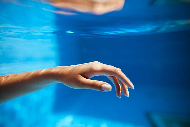 istock Woman hand in pool 590603860