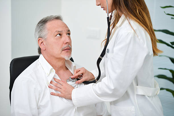 istock Doctor hearing a patient's heartbeat 590606652