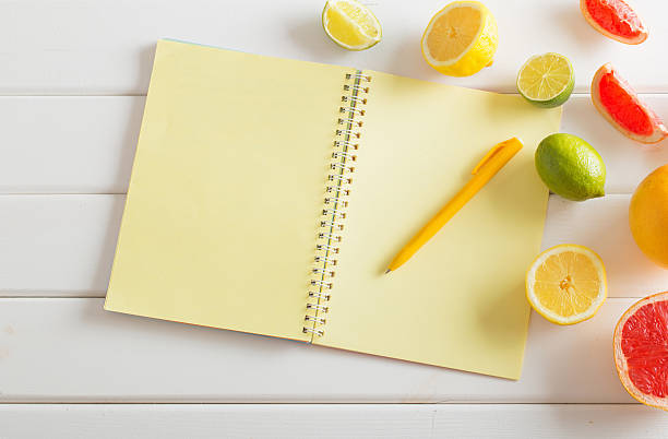 istock citrus with notebook on white wooden table 590607828