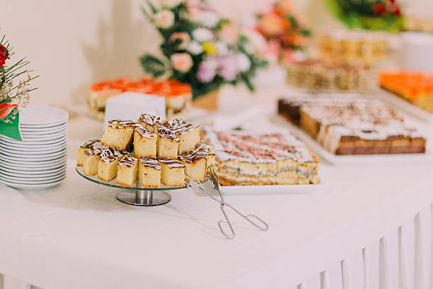 istock Party hall interior. Assortment of fresh sweet pastry on table 590608742