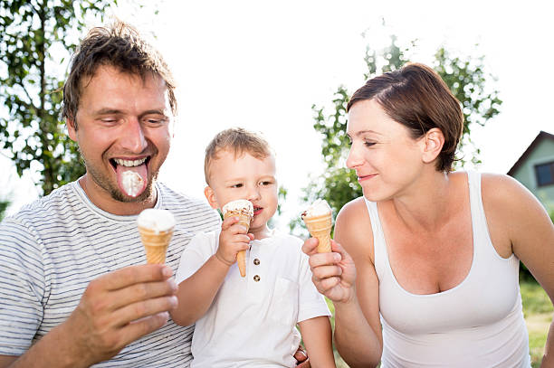 istock Father, mother and son eating ice cream, sunny summer 590609512