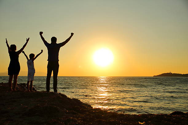 istock Family silhouettes in sunset 590610600