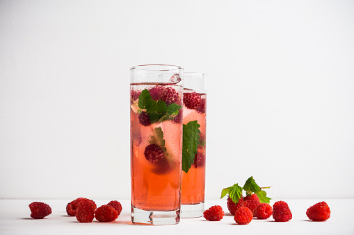 Raspberry cocktail with mint on the wooden background