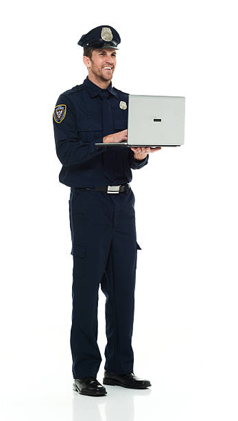 istock Smiling police working on laptop 590611214