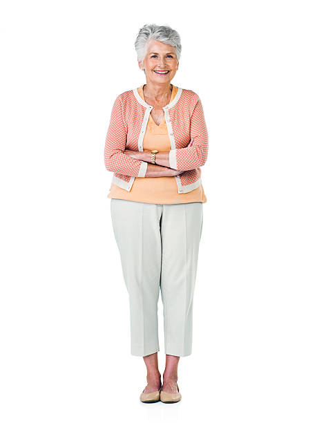 Studio portrait of an elderly woman smiling against a white background