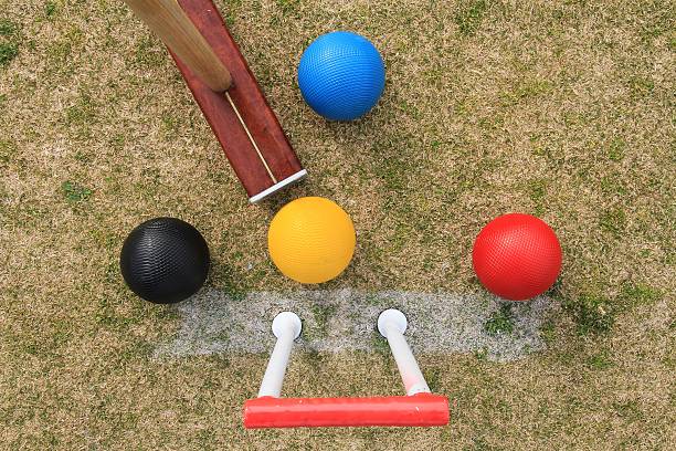 istock Croquet hoop, mallet and balls from above. 590612556