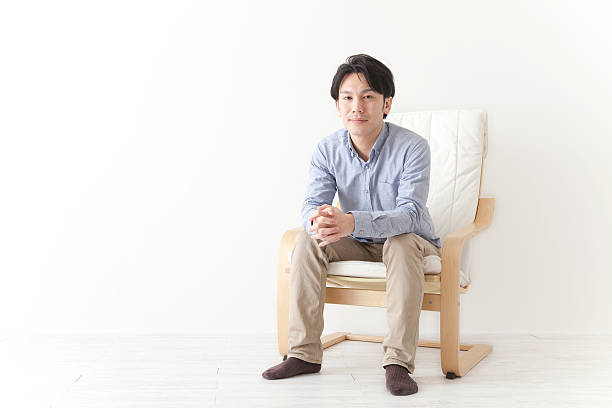 istock Japanese man relaxing in chair 590612812