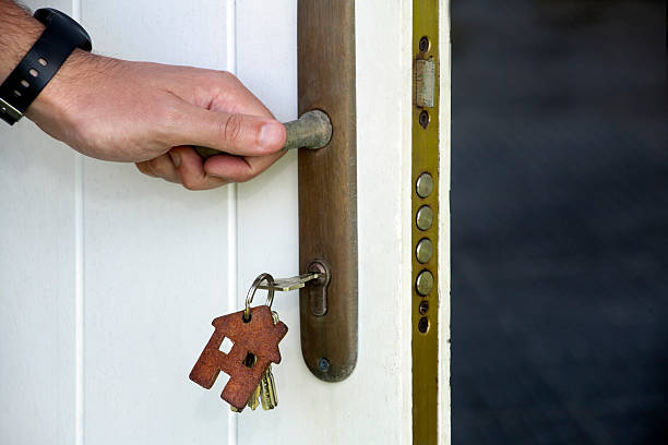 istock Hand, Keys, key ring in house shape, security door. 590613210