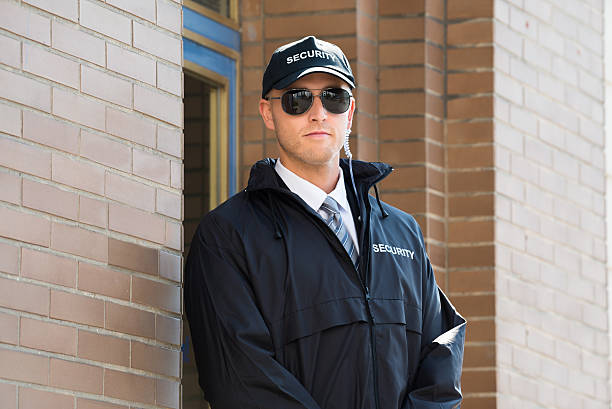 istock Male Security Guard Standing At The Entrance 590615002