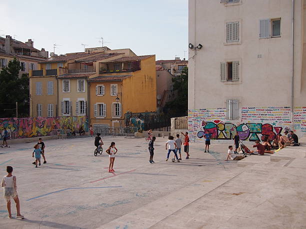 Marseille street football Marseille, France - June 29, 2016: Local kids play street football in the Panier district of Marseille's old town marseille panier stock pictures, royalty-free photos & images