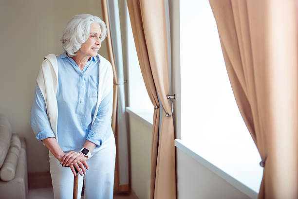 istock Lonely senior woman with crutch 590617566