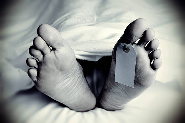 dead body with a blank toe tag, in monochrome stock photo