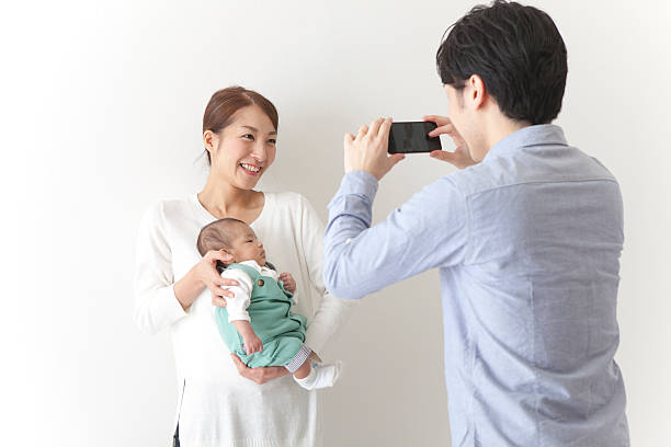 istock Japanese family taking a photo 590620376