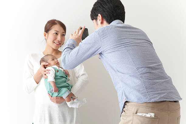 istock Japanese family taking a photo 590620508