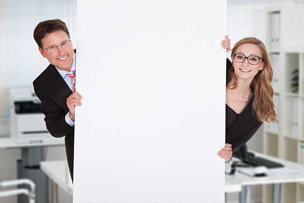 istock Business People Hiding Behind Blank Billboard 590621902