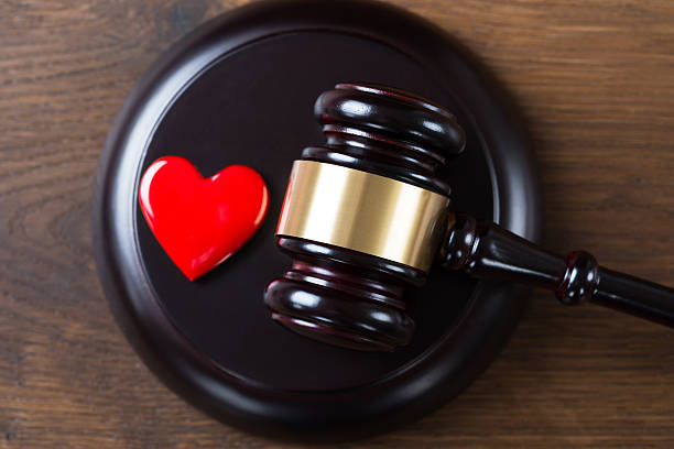istock Mallet And Heart On Table In Courtroom 590625496