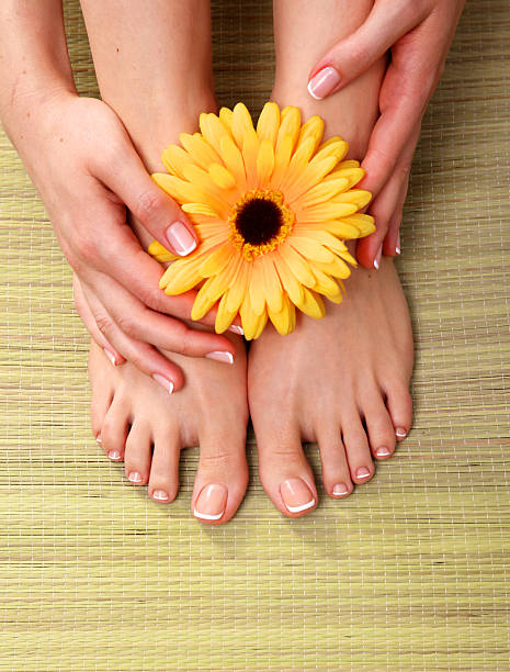 istock pedicure on legs and beautiful manicure hands closeup 590626128