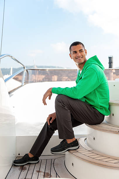 istock Happy man sitting on luxury yacht 590626516