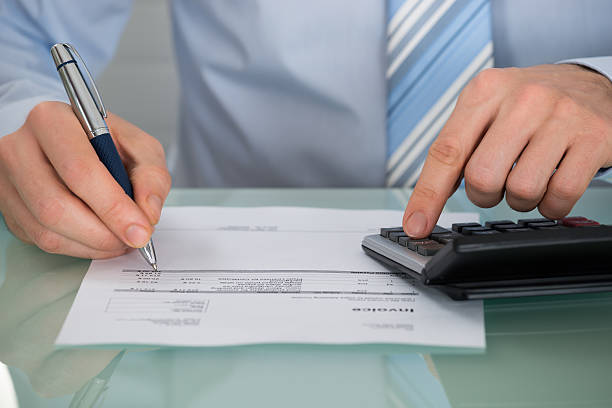 istock Businessman Calculating Invoice With Calculator 590627114