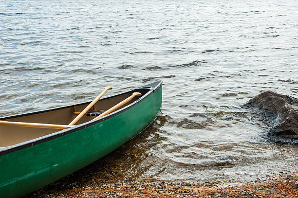 Green canoe on Umbagog Lake, New Hampshire stock photo