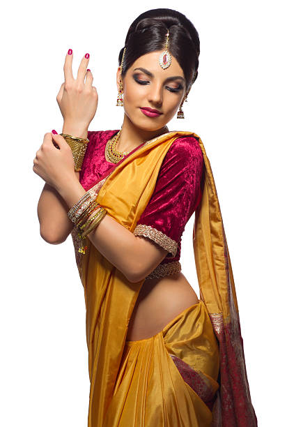 Beautiful Indian female in colorful sari full length portrait in front of marble wall