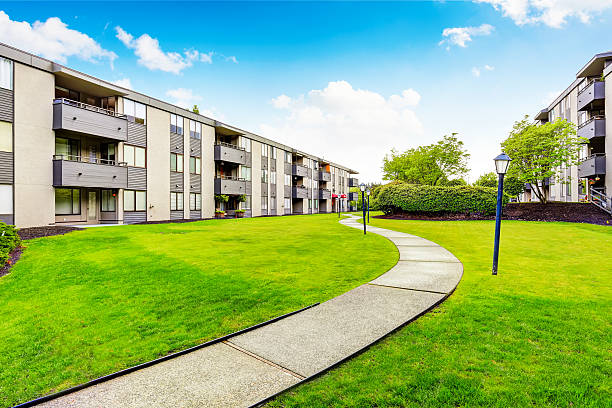 istock Large beige apartment building with three floors and balconies. 591401564