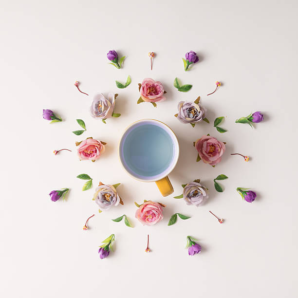 istock Creative arrangement of various flowers with tea cup. 591404930