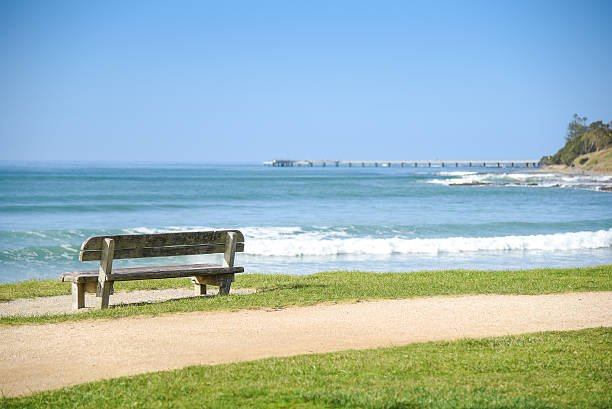 istock Wood bench near beach and sea 591404978
