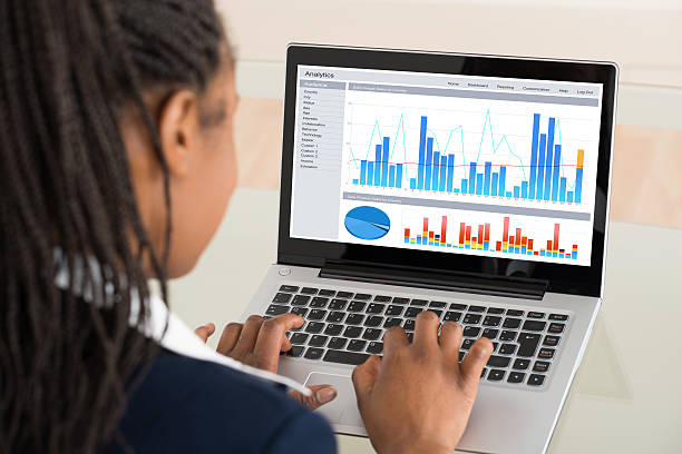 istock Businesswoman Analyzing Graph On Laptop 591405850