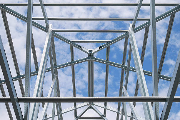 istock Structure of steel roof frame with blue sky and clouds 591407580